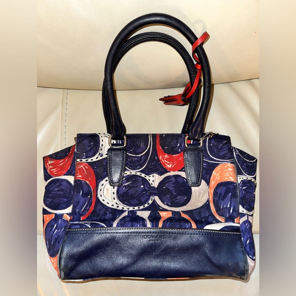 Coach logo bag with orange, red, and beige coloring. leather front and back blen